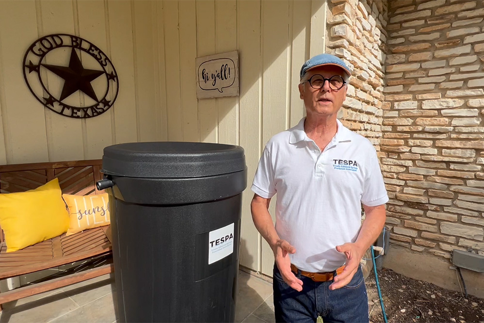 TESPA President Andrew Weber awards ten 50-gallon rain barrels to residents